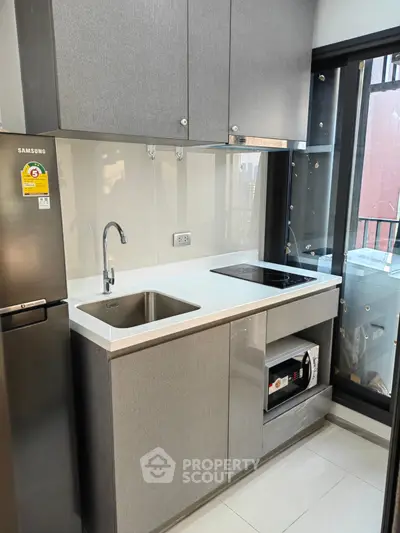 Modern kitchen with sleek cabinetry and built-in appliances in a stylish apartment.