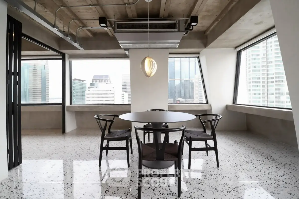Modern dining area with city view and stylish lighting in urban apartment