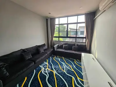Spacious living room with modern design and large window view