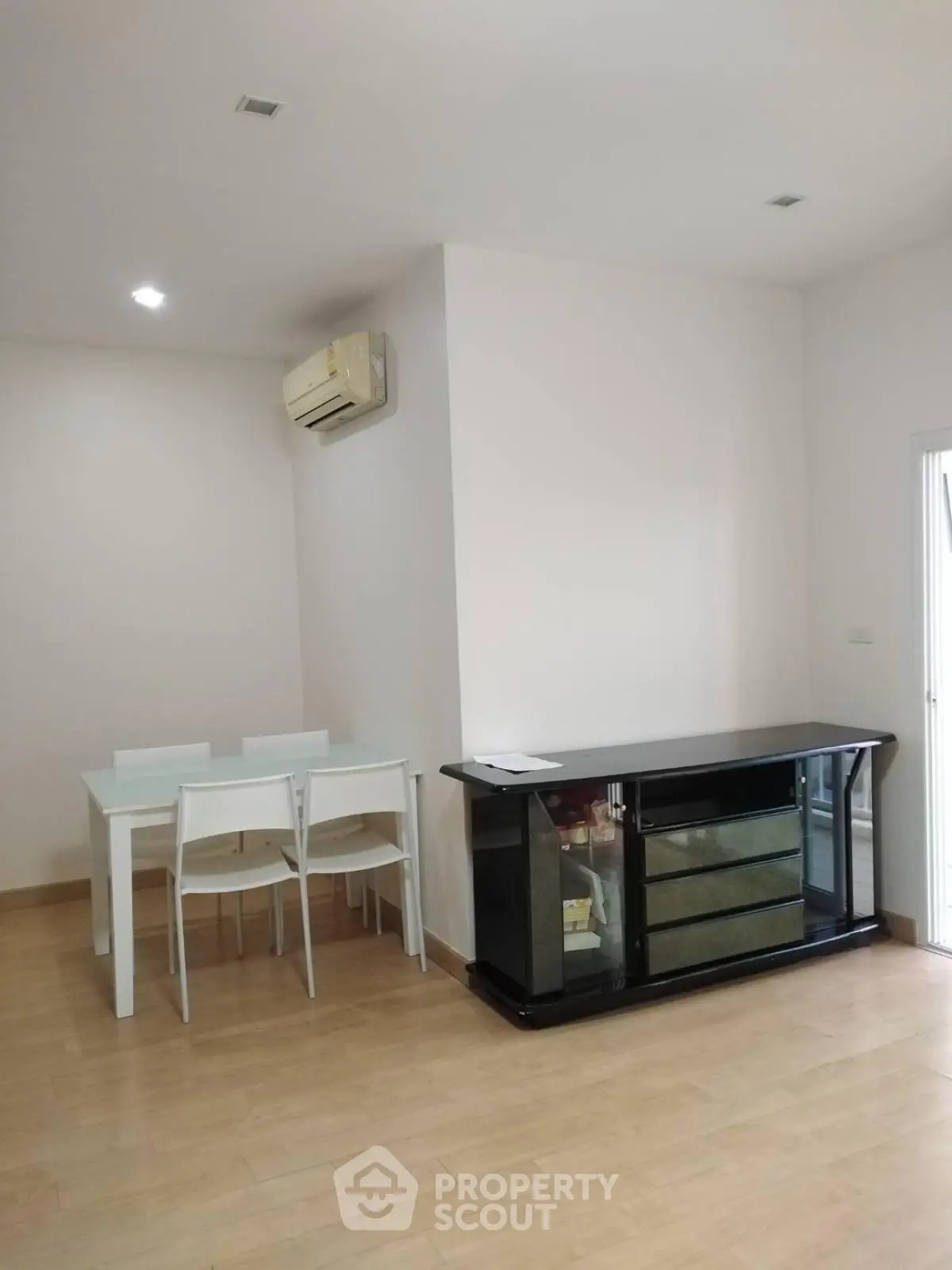 Modern dining area with sleek furniture and air conditioning in a bright apartment