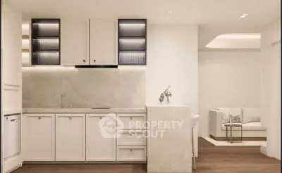 Modern kitchen with sleek cabinetry and open layout adjacent to cozy living area.