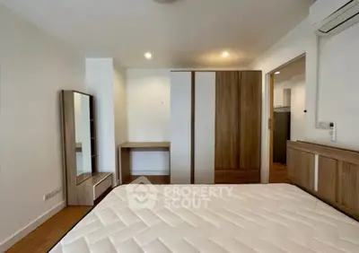 Spacious bedroom with modern wooden furniture and ample natural light