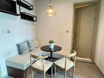 Cozy dining nook with modern seating and stylish lighting in a compact space.