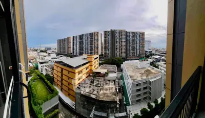 Panoramic view of modern urban residential buildings from a balcony, showcasing cityscape and architecture.