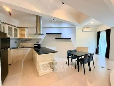 Modern open-layout kitchen with dining area and sleek design