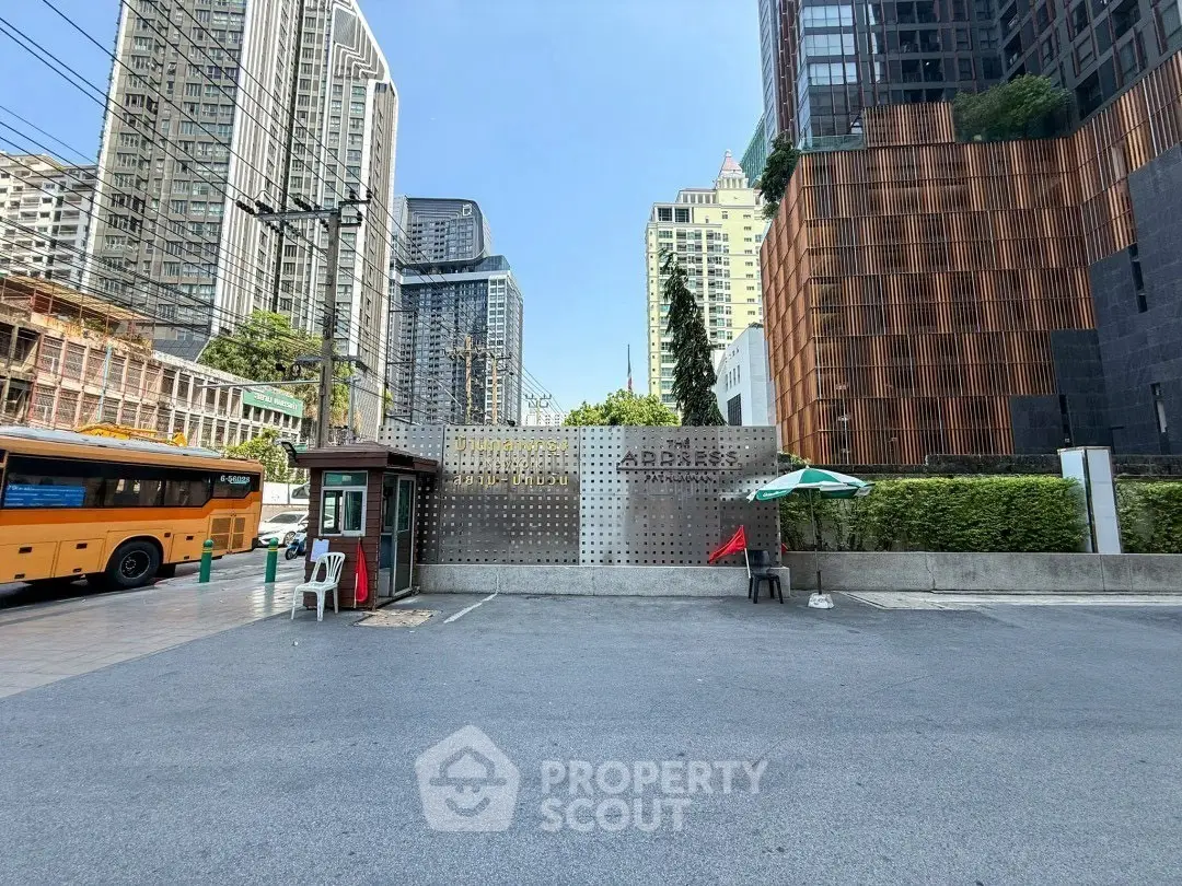 Modern urban building entrance with cityscape view and parking area