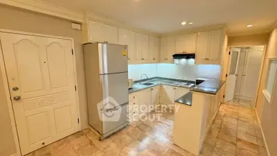 Charming kitchen with closed layout and modern appliances in cozy apartment