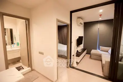 Modern apartment interior with cozy living room, bedroom, and bathroom, featuring sleek design and neutral tones.