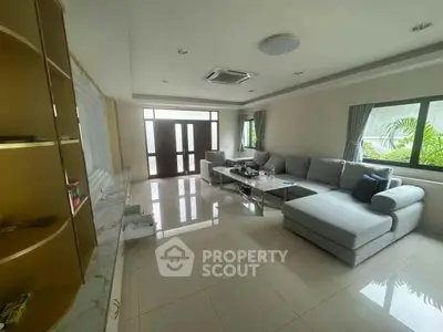 Spacious living room with modern furniture and large windows for natural light.