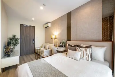 Luxurious modern bedroom with elegant decor and cozy seating area
