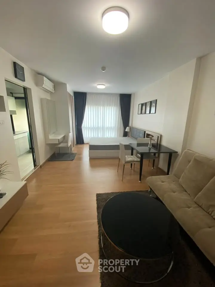 Modern studio apartment with open layout, featuring a cozy living area and stylish furnishings.