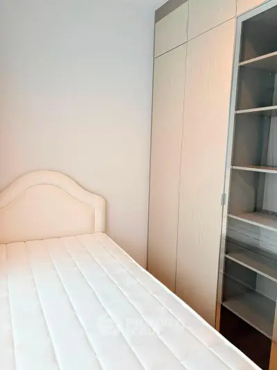 Modern bedroom with sleek wardrobe and comfortable bed in a stylish apartment.