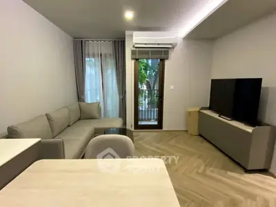 Modern living room with sleek furniture and balcony view