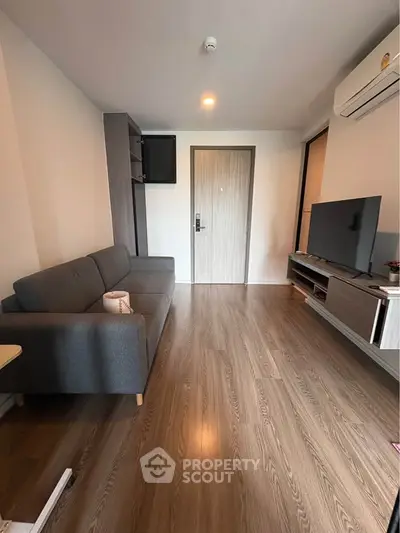 Modern living room with sleek furniture and wooden flooring