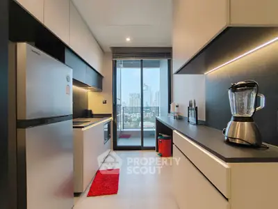 Modern kitchen with sleek design and city view from balcony