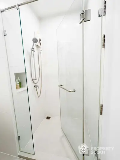 Modern bathroom with a spacious glass-enclosed shower, sleek fixtures, and minimalist design, perfect for a contemporary home.