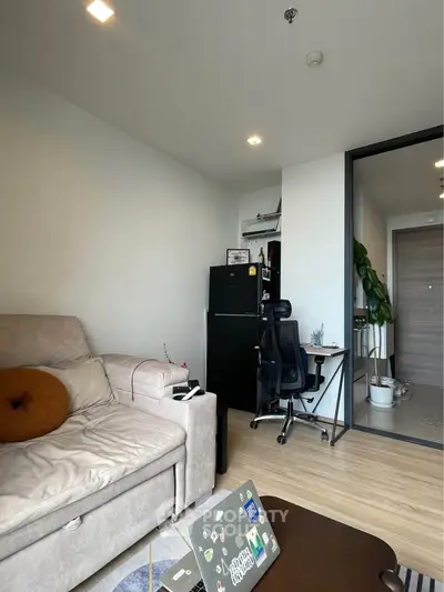 Modern living room with cozy sofa and workspace in stylish apartment