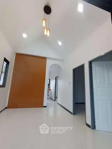 Spacious modern interior with high ceilings and elegant lighting, showcasing a sleek hallway design.