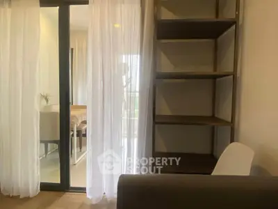 Modern apartment interior with sliding glass doors and elegant shelving unit.