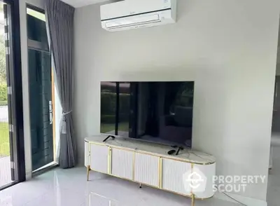 Modern living room with sleek TV setup and air conditioning