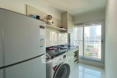 Modern kitchen with city view, featuring sleek appliances and ample natural light.