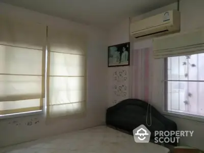 Cozy bedroom with air conditioning and soft lighting, perfect for relaxation.