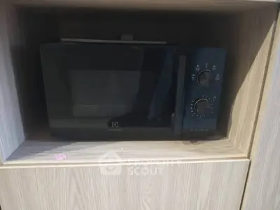 Modern built-in microwave in sleek wooden cabinetry, perfect for contemporary kitchens.