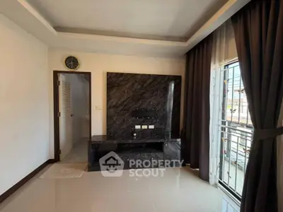 Modern living room with marble feature wall and large window view