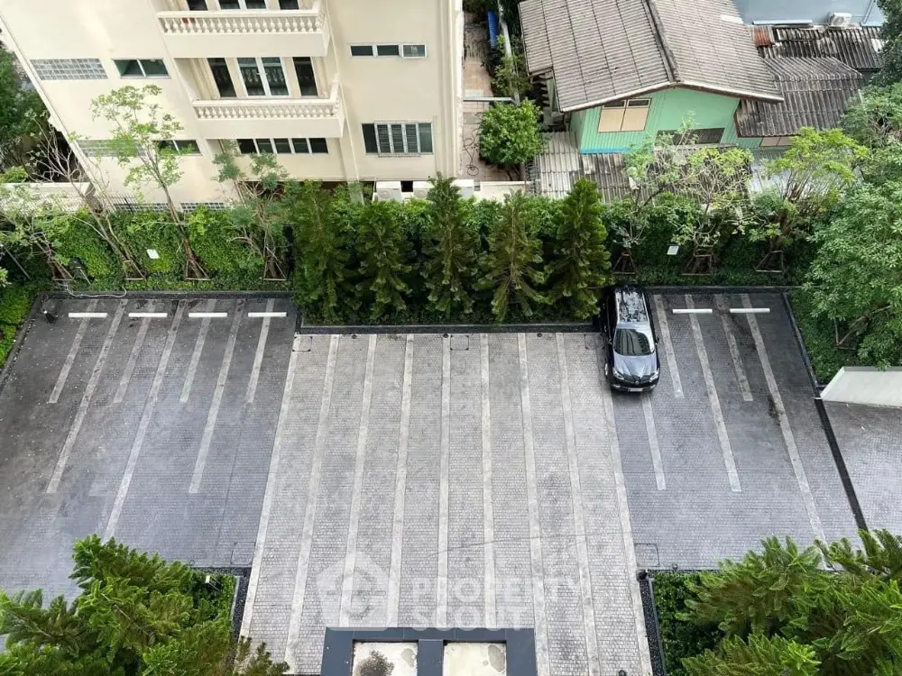 Spacious parking area with greenery in a residential complex