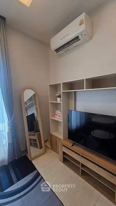 Modern living room with air conditioning and sleek TV setup