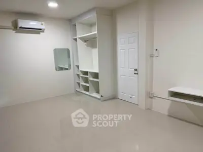 Spacious unfurnished room with built-in storage and air conditioning