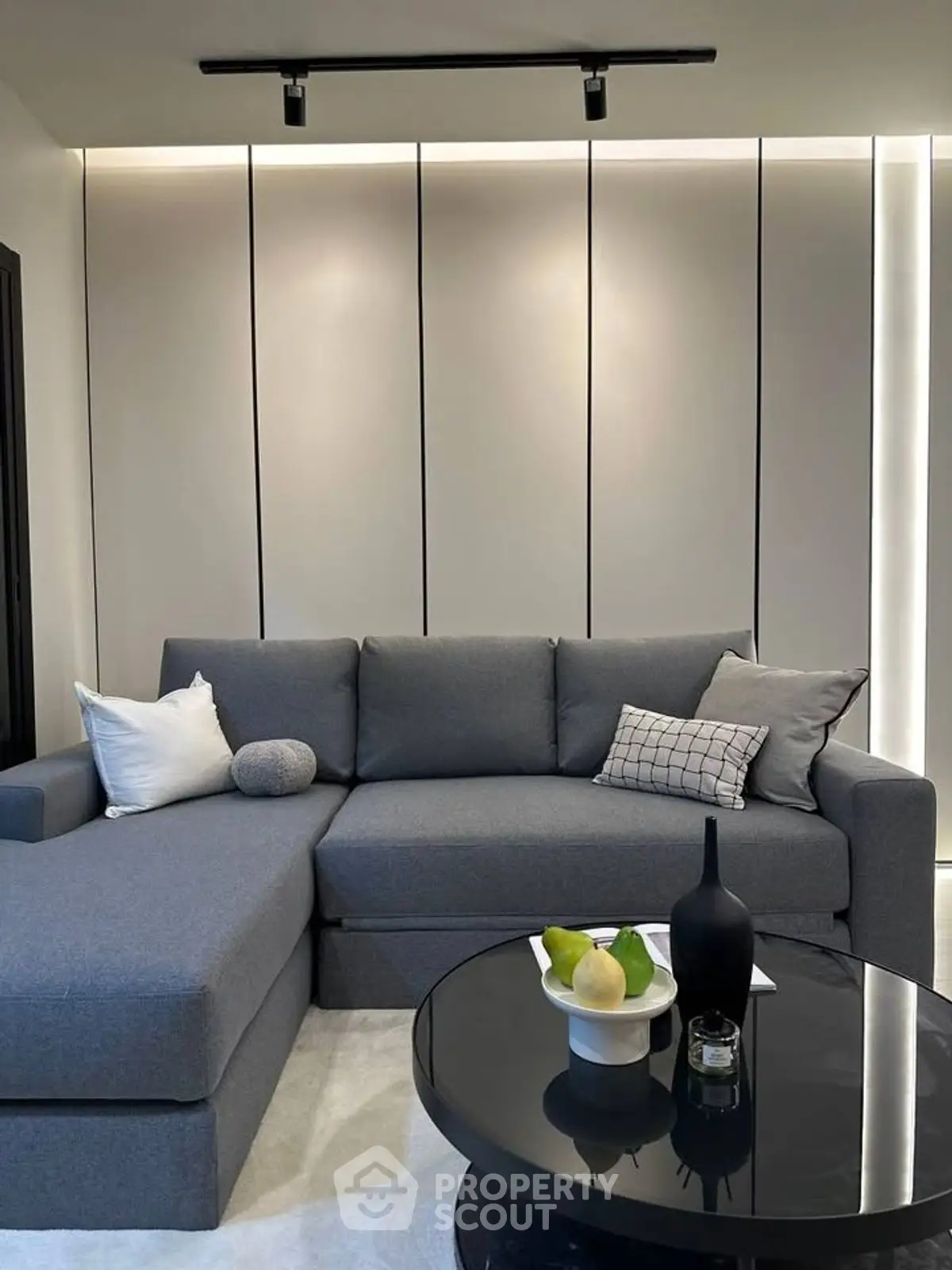 Modern living room with sleek gray sectional sofa and stylish coffee table