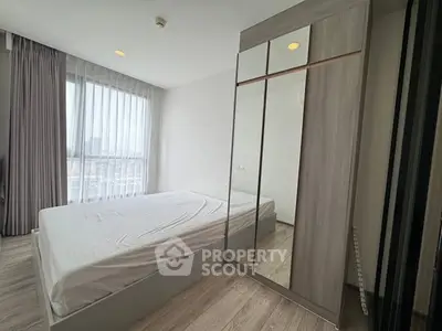 Modern bedroom with large window and sleek wardrobe design