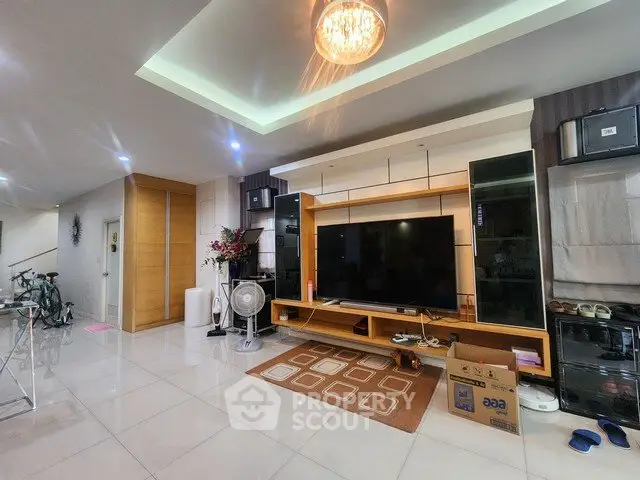 Spacious living room with modern decor and large TV unit