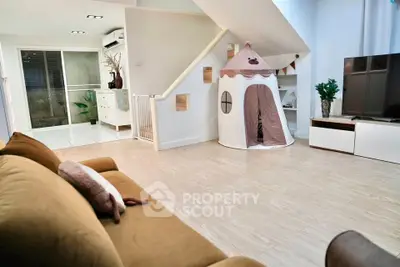Charming living room with cozy sofa and playful tent, perfect for family relaxation.