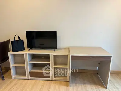 Modern living room with sleek TV stand and compact desk, perfect for urban apartments.
