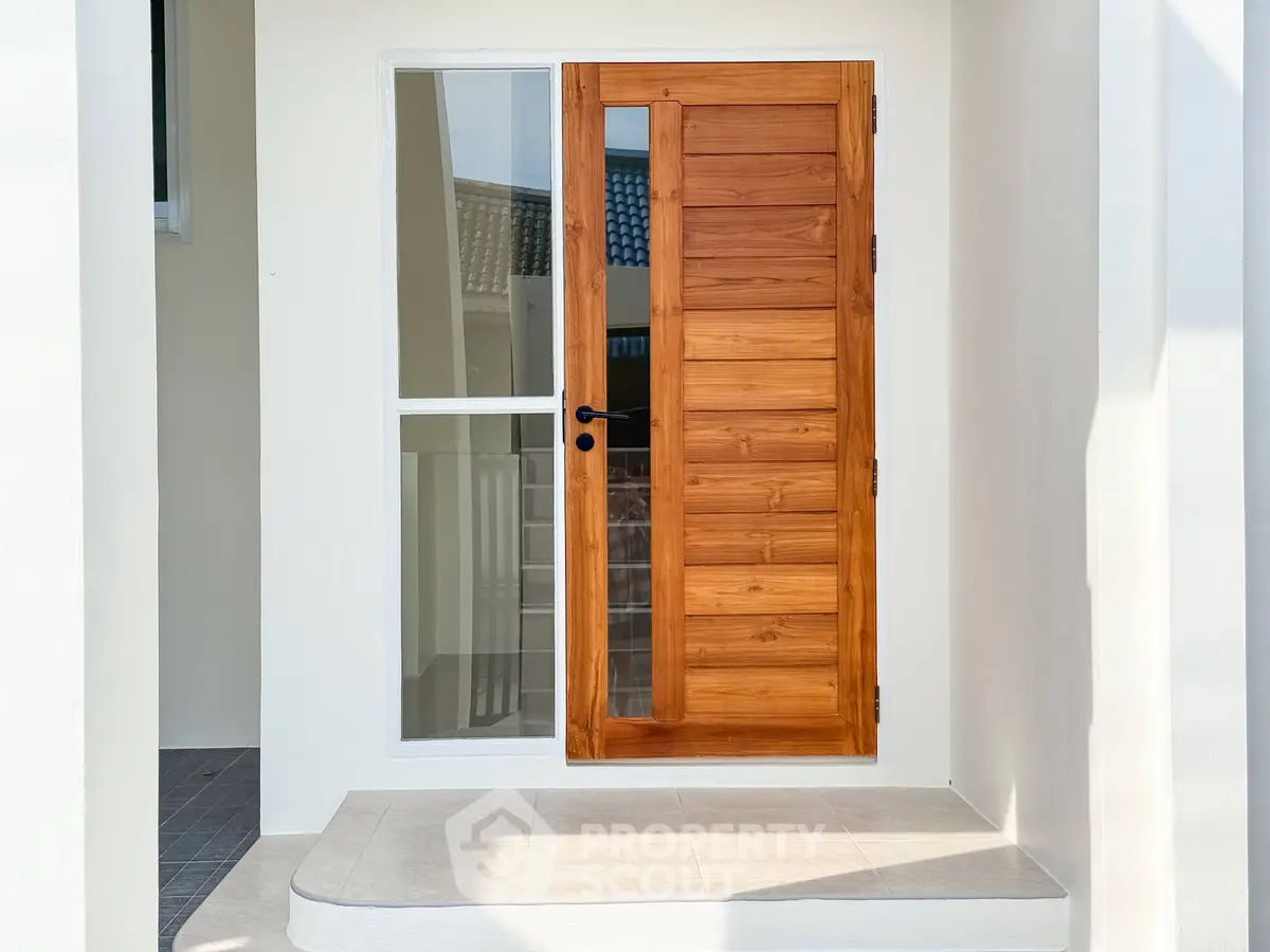 Modern wooden door with glass panel in a stylish entranceway