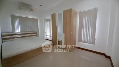 Spacious bedroom with modern wooden furniture and natural light