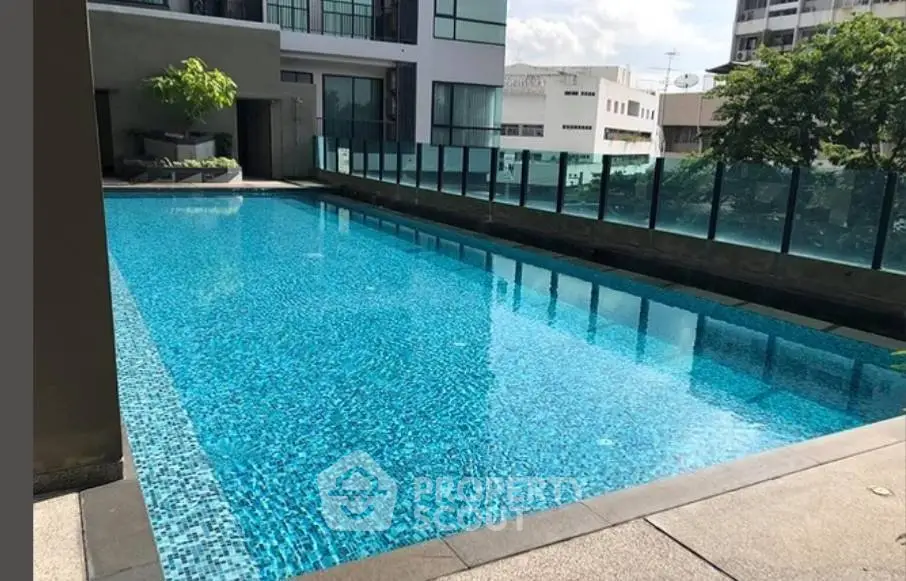 Luxurious rooftop pool with stunning city views in modern apartment complex.