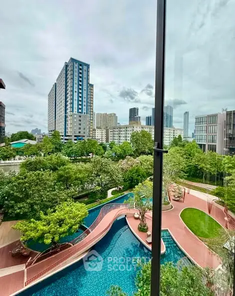 Stunning view of modern high-rise buildings and lush landscaped gardens with a serene pool.
