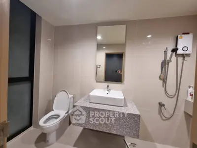 Modern bathroom with sleek fixtures and neutral tiles