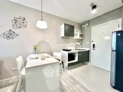 Modern kitchen with sleek design, featuring open layout and stylish dining area, perfect for urban living.