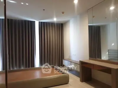 Spacious bedroom with modern decor and large windows