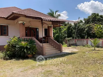 Charming single-story house with lush garden and inviting entrance