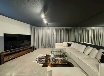 Luxurious modern living room with sleek design and spacious seating area.