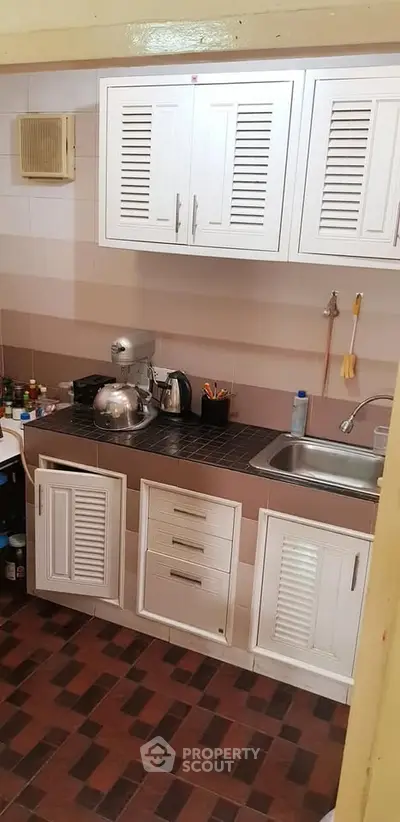 Charming kitchen with closed layout and modern appliances, perfect for culinary enthusiasts.