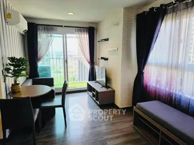 Modern living room with large windows and stylish decor, offering a bright and inviting atmosphere.