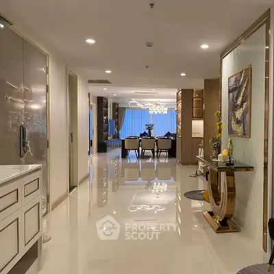Luxurious open-plan living and dining area with elegant decor and modern lighting.