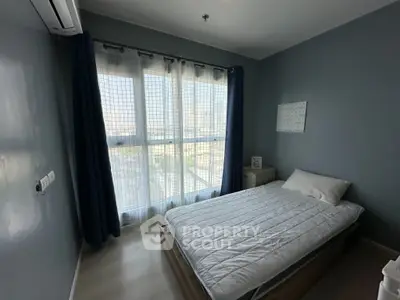 Cozy bedroom with large window and modern decor