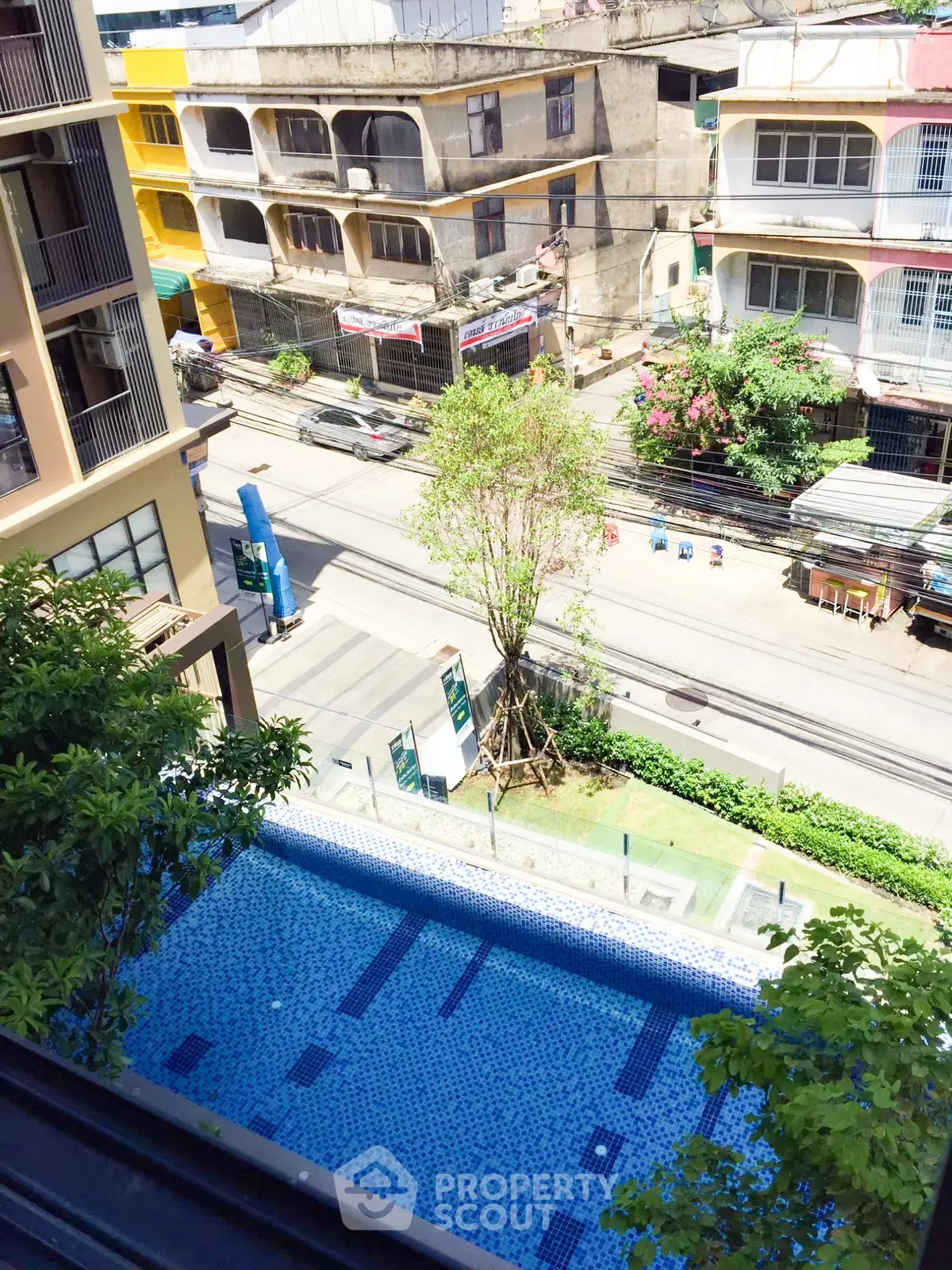 Stunning aerial view of a residential pool with urban surroundings, perfect for city living.